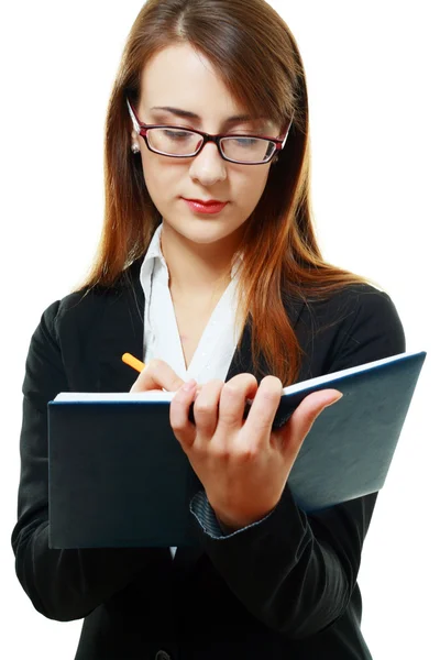 Smiling young woman writing — Stock Photo, Image