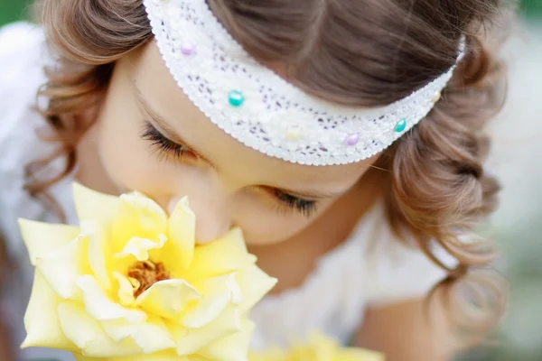 Girl smelling rose — Stock Photo, Image