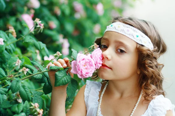 Girl smelling rose — Stock Photo, Image