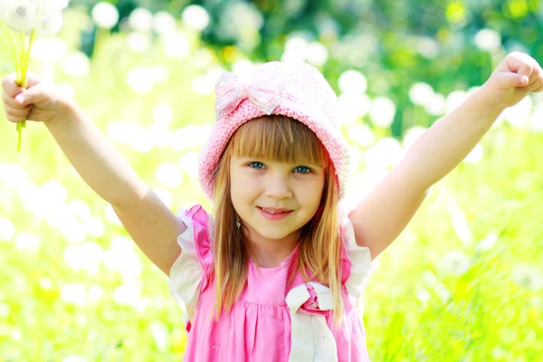 Girl have fun with dandelions — Stock Photo, Image