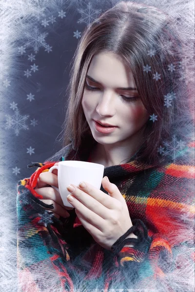 Woman warming by cup of coffee or tea — Stock Photo, Image