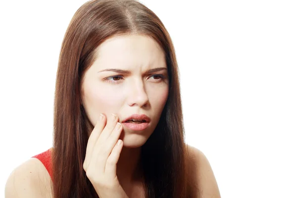 Vrouw op haar gekneusd Wang te drukken — Stockfoto