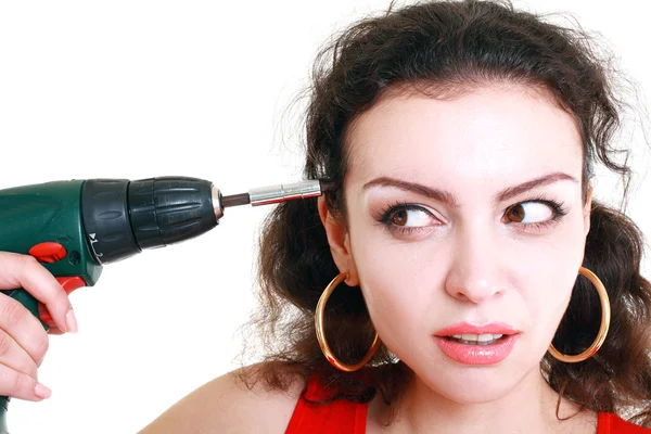 Girl with a drill drills head — Stock Photo, Image