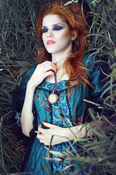 Young woman on the grass outdoors fashion portrait style Boho. Fashion color tint