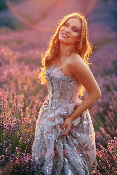 ラベンダー畑のイブニングドレスの美しい女性 — ストック写真
