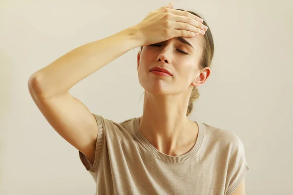 Portrait Upset Woman Holding Hand Her Forehead Posing Next Color — Stockfoto