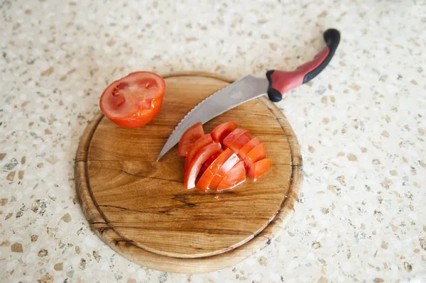 Sliced tomato and a knife — Stock Photo, Image