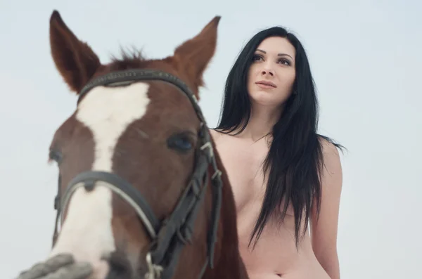 Naked woman on a horse — Stock Photo, Image