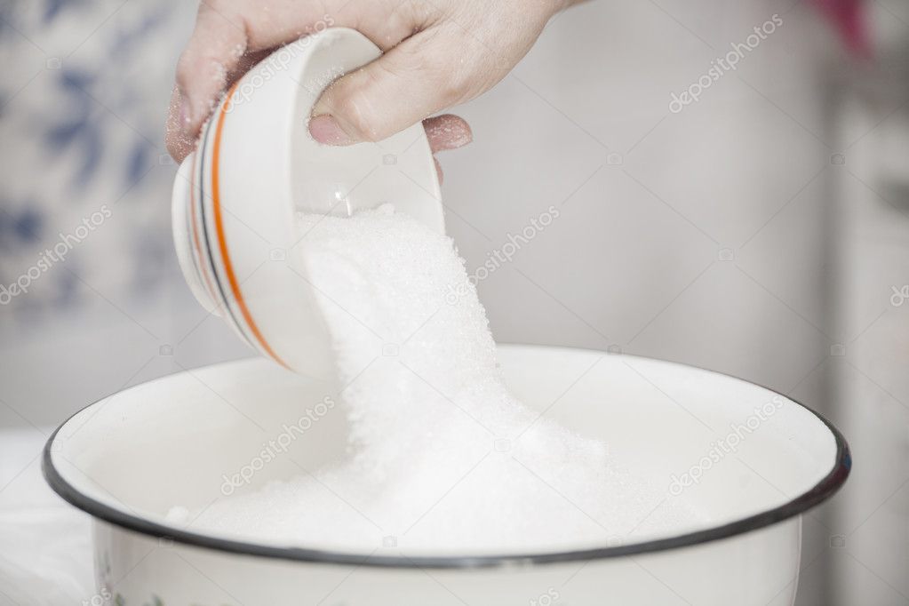 hand pours sugar
