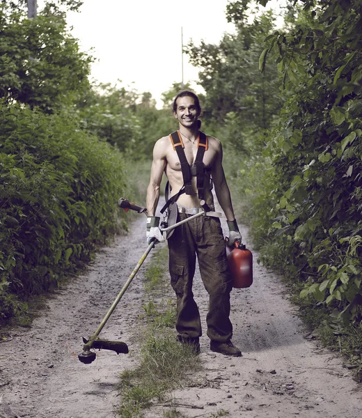 Cute gardener with lawn mower — Stock Photo, Image