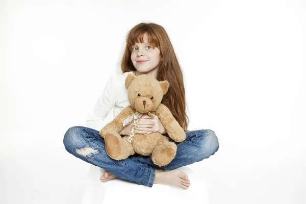 Red-haired teen girl and teddy bear — Stock Photo, Image