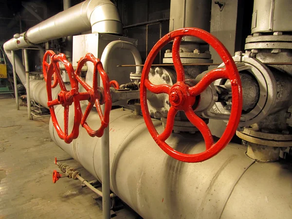 Pipes and valves with red knobs — Stock Photo, Image