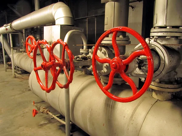 Pipes and valves with red knobs — Stock Photo, Image