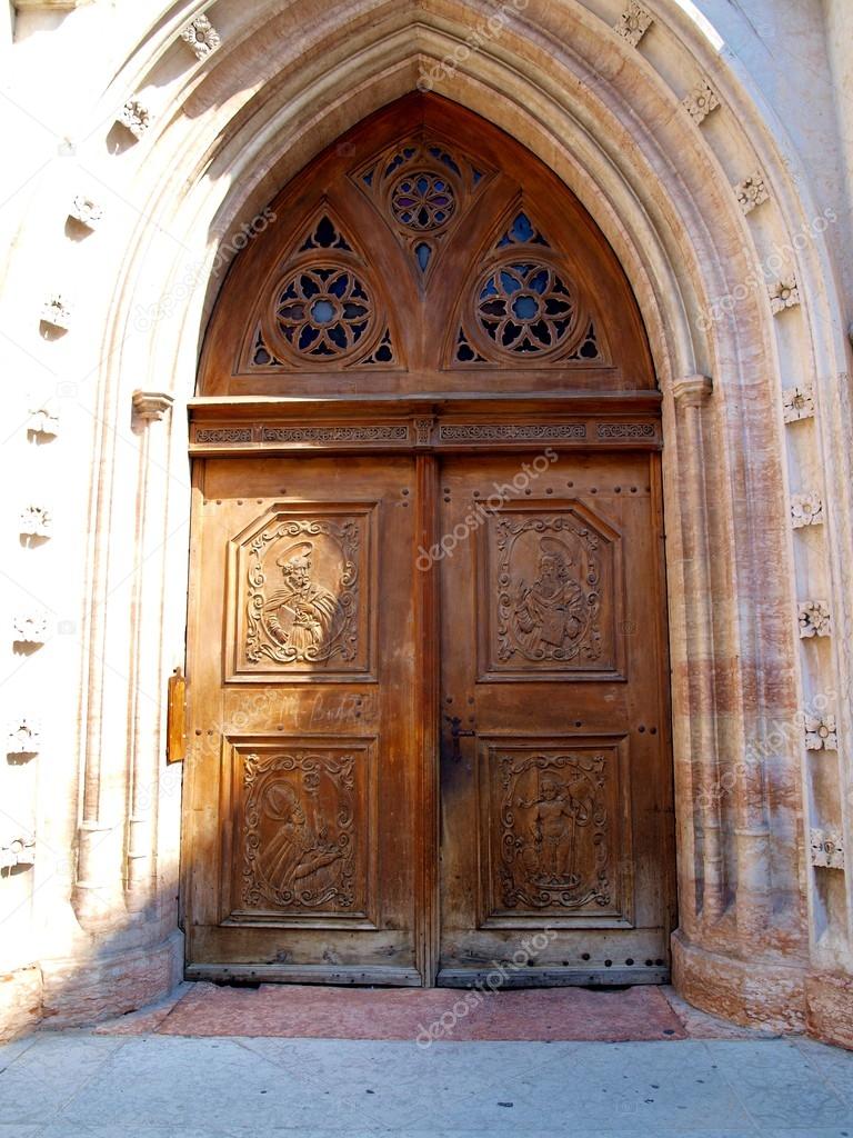 Wooden door to the Church of St. Peter in Trento