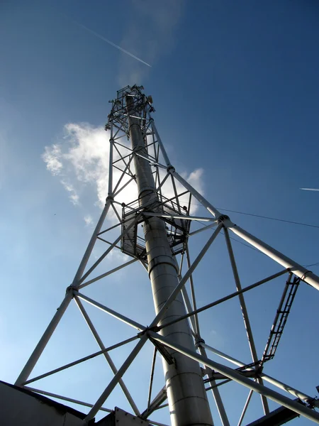 Metal industrial chimney against a blue sky with clouds — Stock Photo, Image