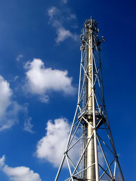 Metal industrial chimney against a blue sky with clouds — Stock Photo, Image