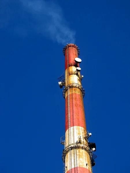 A tall chimney with smoke visible — Stock Photo, Image