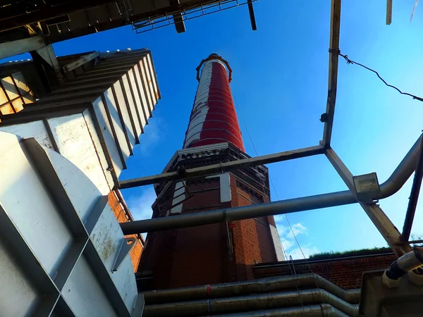 Oude, hoge industriële schoorsteen van baksteen en uitlaat leidingen — Stockfoto