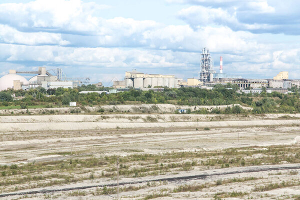 a chalk opencast mine in Chelm in eastern Poland, a cement plant visible in the distance
