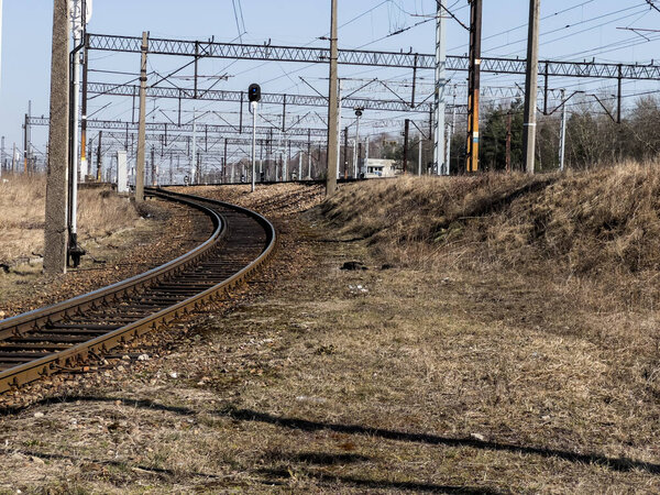 A side railroad track leading from the main railroad. An illustration to say "set aside on the side track", "take it aside", "make it unimportant", set aside on the side track