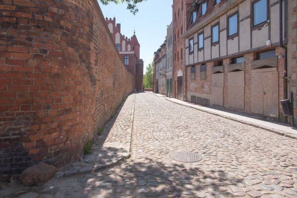 View of the Gothic brick defensive walls in the historic city center of Torun, Poland.