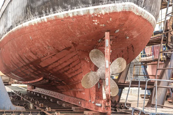 The hull and propeller of a fishing boat during renovation in the port of Wladyslawowo in Poland.