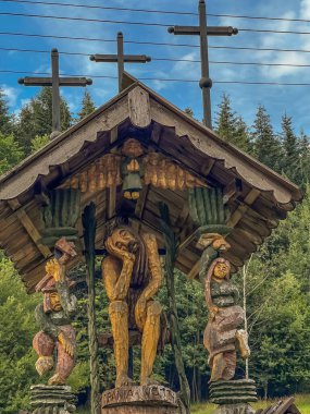 Zabnica, Poland, July 27, 2022: Wayside shrines and saints and various sculptures in the village of Zabnica in the Beskid Zywiecki mountains in Poland.