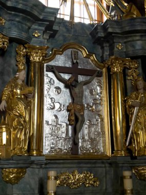Truskolasy, Poland, July 9, 2022: Sanctuary of Our Lady of Grace in Truskolasy. The largest larch church in Poland. Side altar with a cross.