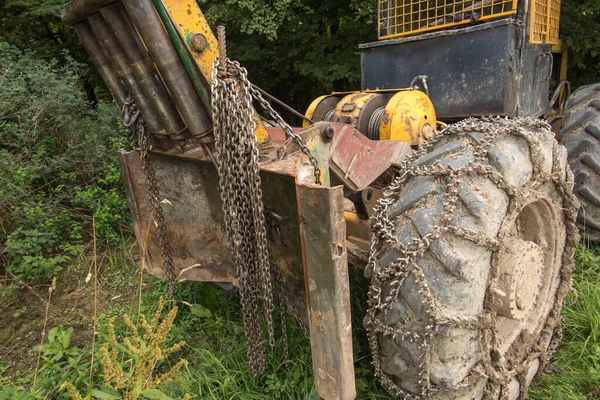 Chain on the wheels of a skidder, i.e. a tractor for skidding wood in difficult mountain terrain and with earthen ground.