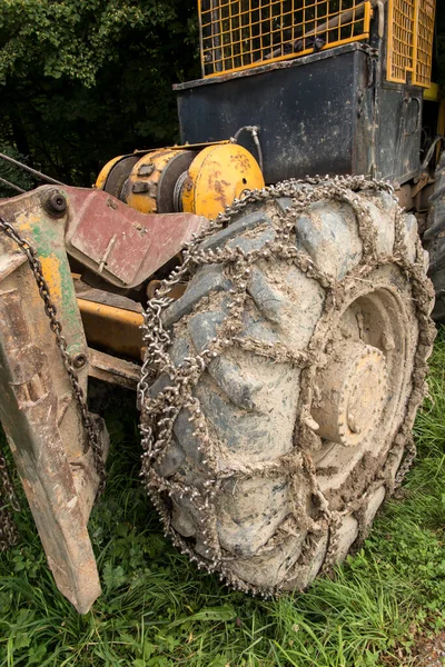 Chain on the wheels of a skidder, i.e. a tractor for skidding wood in difficult mountain terrain and with earthen ground.