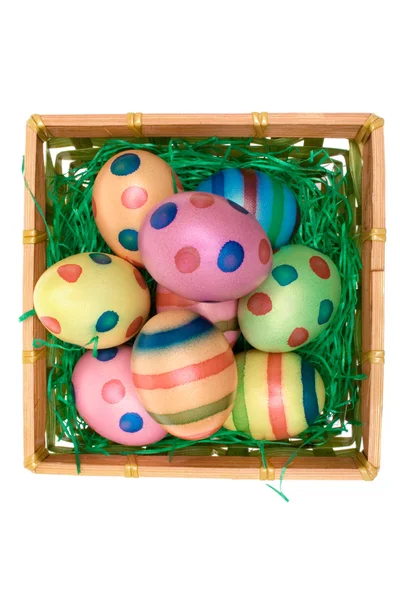 Colored Eggs in a Wooden Basket — Stock Photo, Image