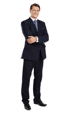 Attractive businessman standing with arms crossed