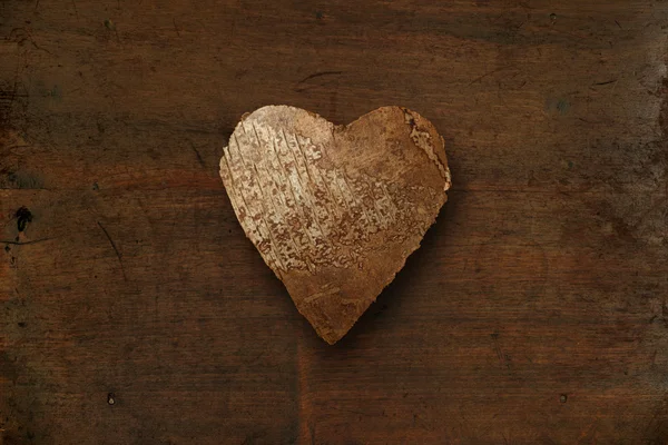 Wood heart on dark wood background — Stock Photo, Image