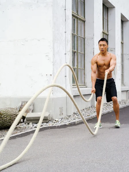 Working out with training ropes — Stock Photo, Image