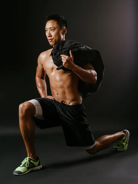 Man doing lunge exercises with sand bag — Stock Photo, Image