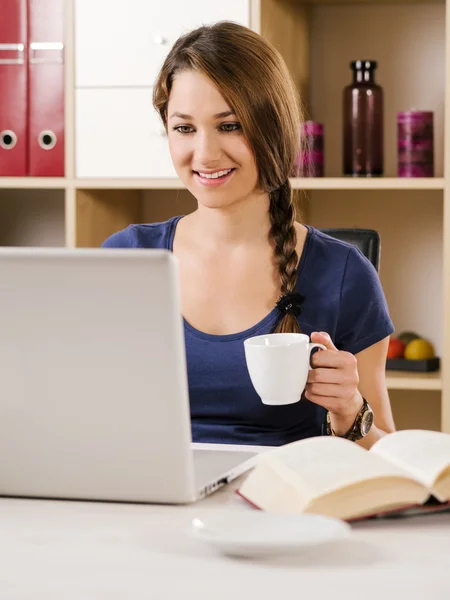 Piękna kobieta uśmiechając się podczas korzystania z laptopa — Zdjęcie stockowe
