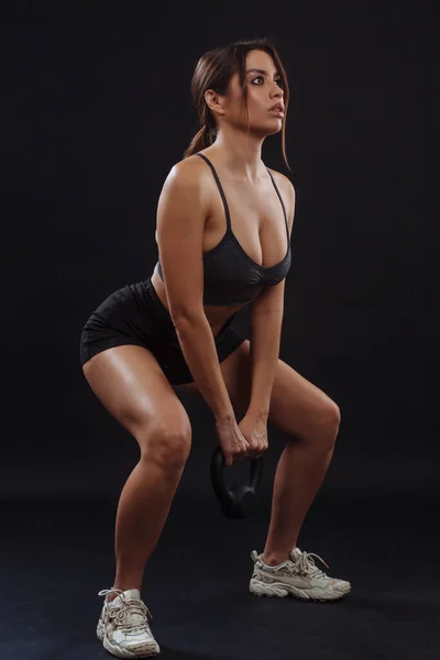 Fit Young Woman Doing Squats While Lifting Kettle Bell — Stock Photo, Image