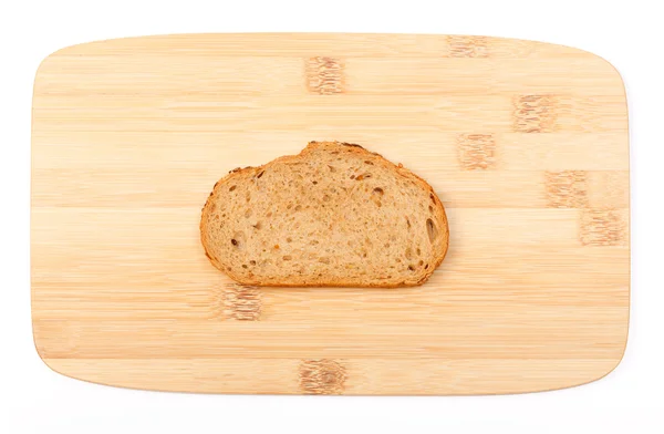 Brown bread slice on bamboo board — Stock Photo, Image