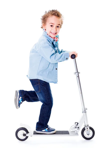 Rapaz alegre indo rápido com scooter — Fotografia de Stock