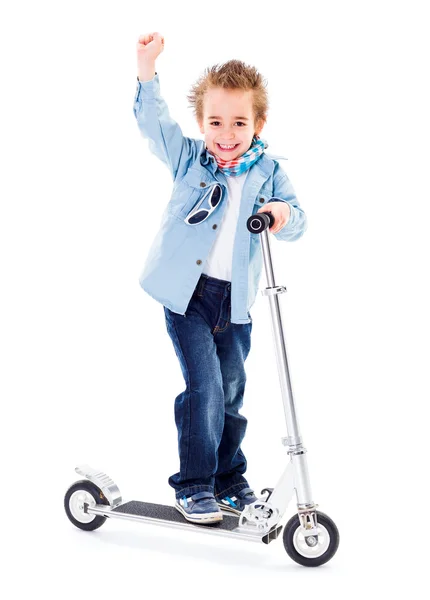 Cheerful boy with raised hand on scooter white background — Stock Photo, Image