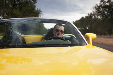 Trendy man steering sportcar clipart