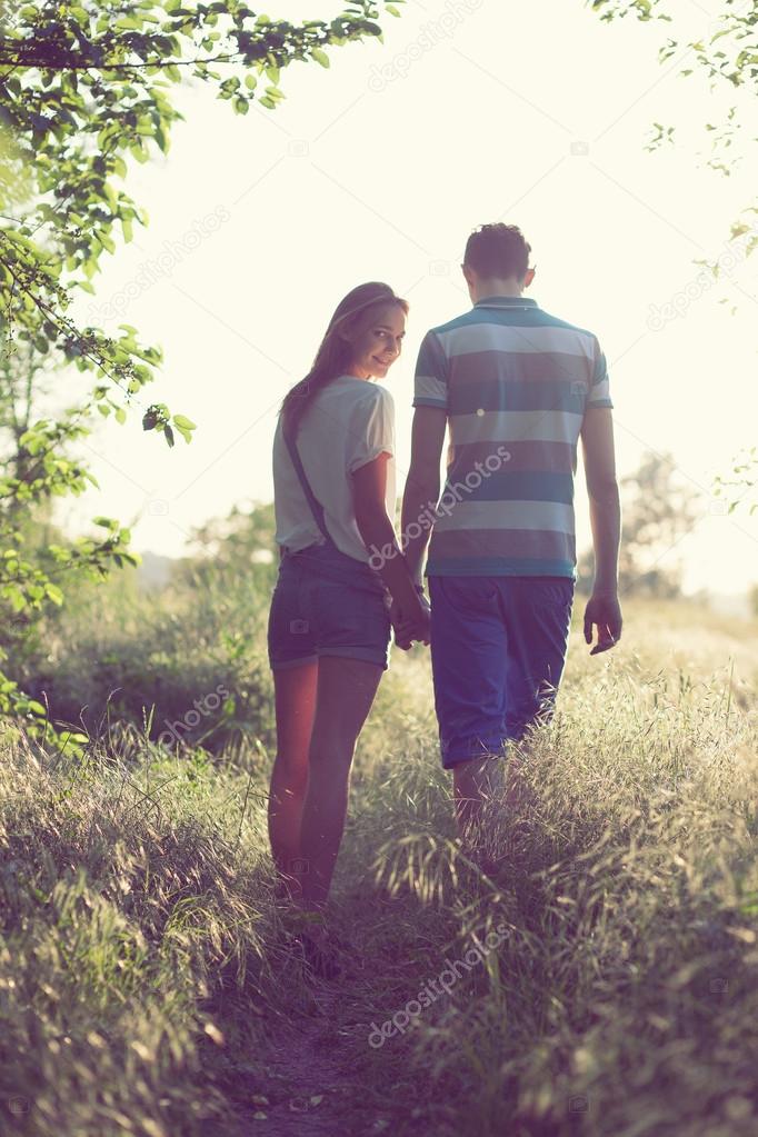 Walking loving couple at sunset