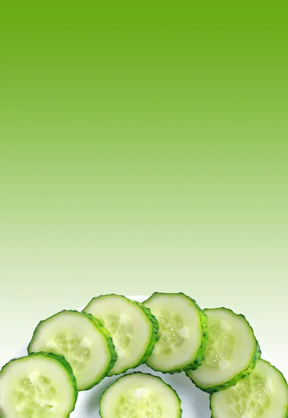 Sliced cucumber on green background — Stock Photo, Image