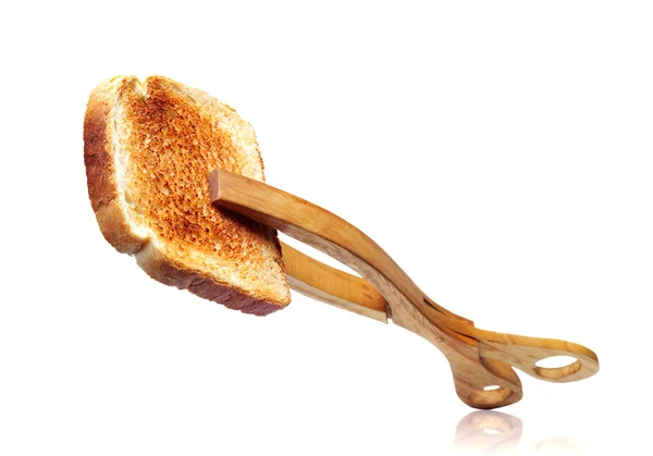 Toast bread with wooden tongs — Stock Photo, Image