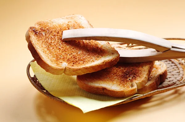 Wooden tongs and toast — Stock Photo, Image