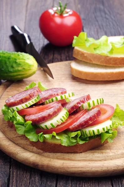 Smørbrød med pølse, salat, tomat og agurk – stockfoto