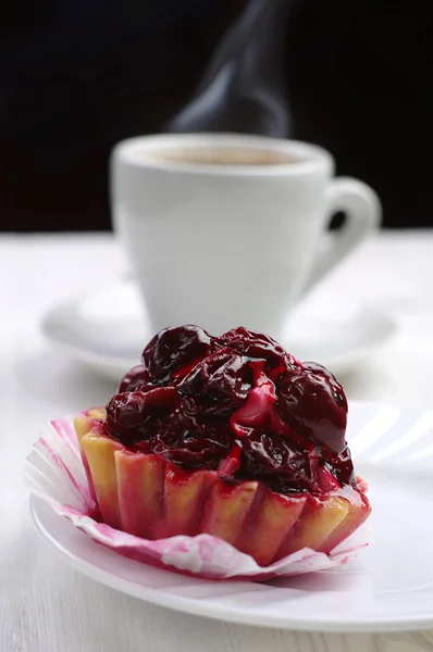 Cake with cherry and cup of coffee — Stock Photo, Image