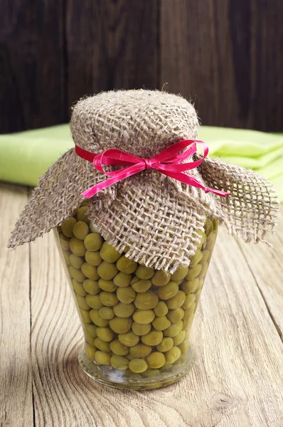 Green peas in glass jar — Stock Photo, Image