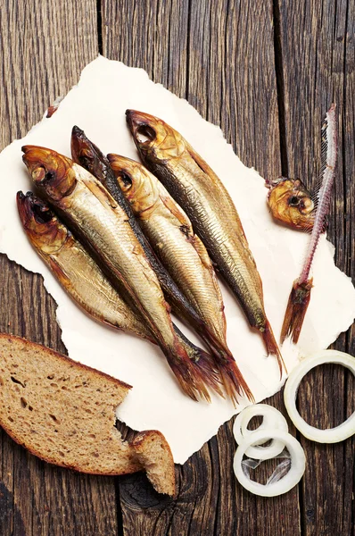 Smoked fish on wooden table — Stock Photo, Image