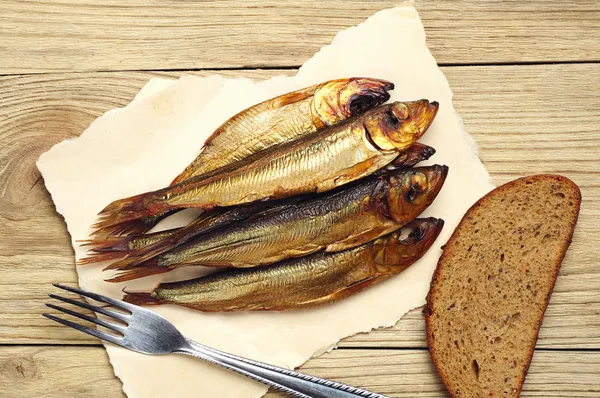Golden smoked fish on board — Stock Image Golden smoked fish on board Royalty Free Stock Photos